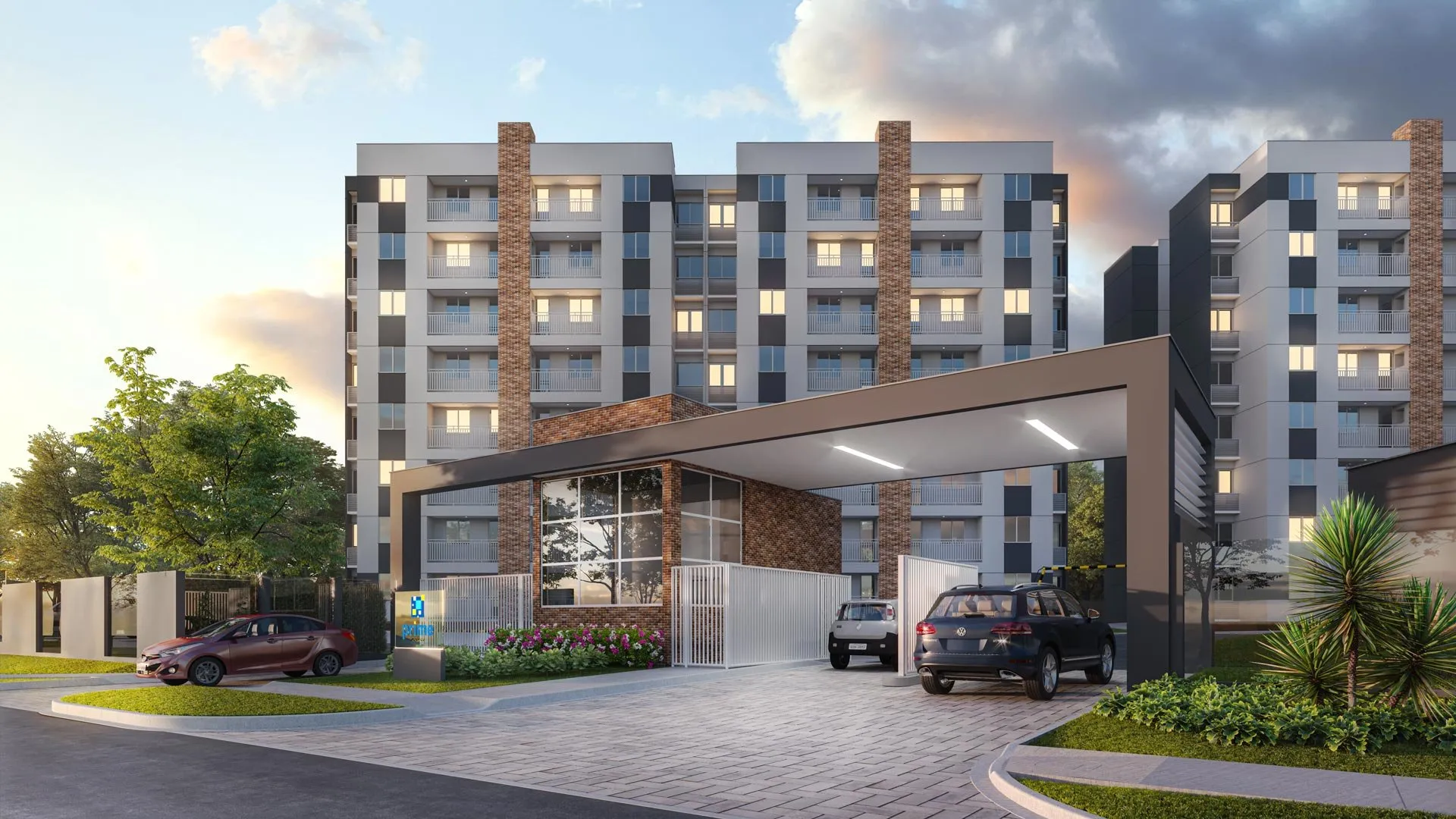 Condomínio residencial projetado pela PortoVene ao entardecer, visto da rua: torres de apartamentos, guarita e portão de entrada